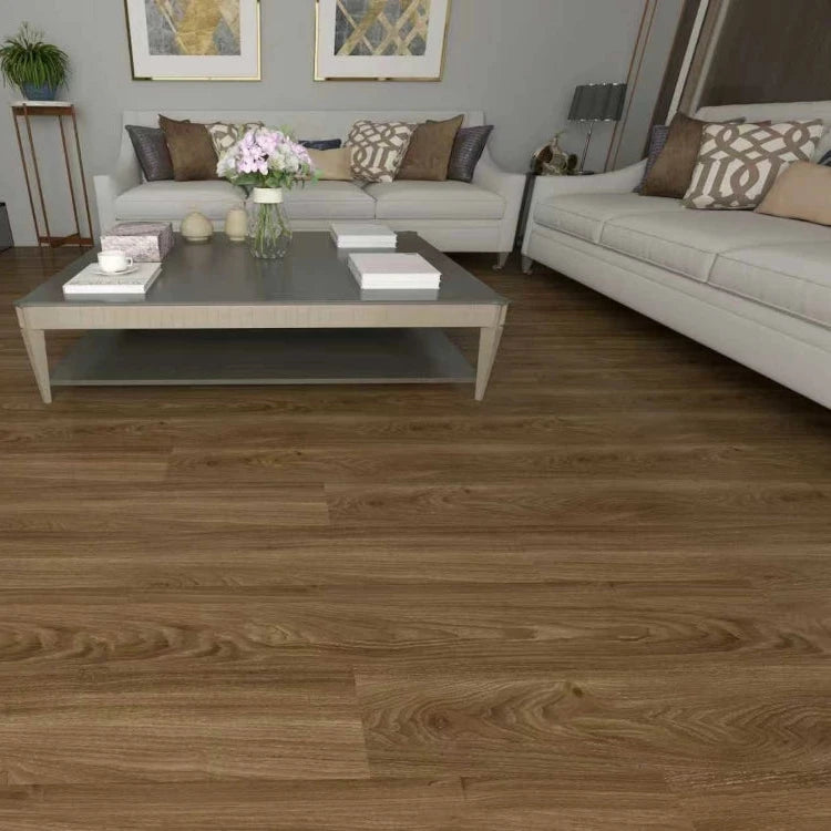 Brown wood-look laminate or vinyl flooring shown installed in a modern living room setting with a gray coffee table, white sofas, and neutral decor.