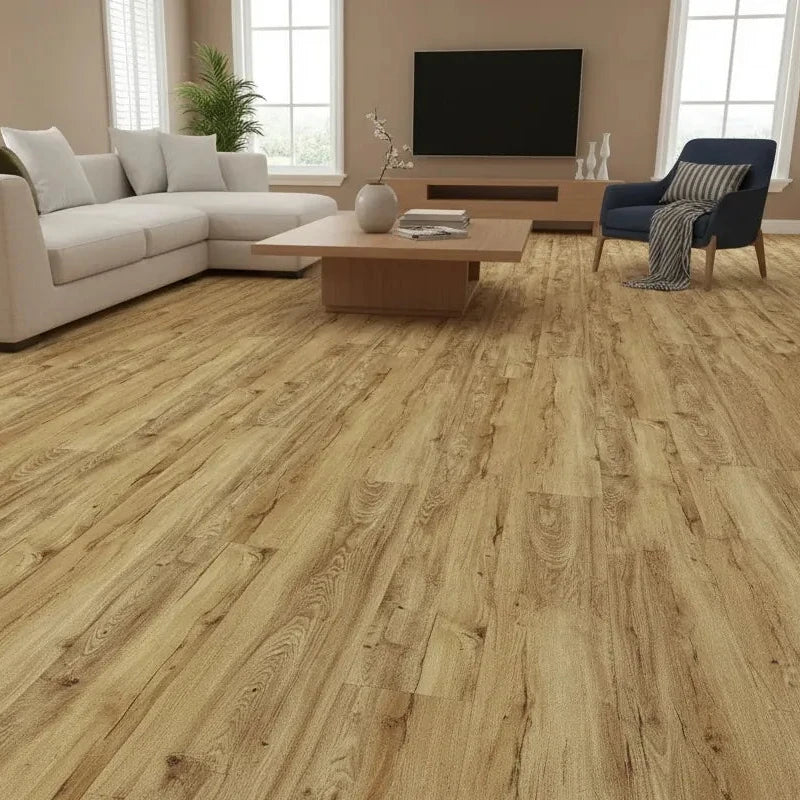 Light oak wood plank flooring shown installed in a modern living room with a white sectional sofa, blue armchair, coffee table, and large windows.